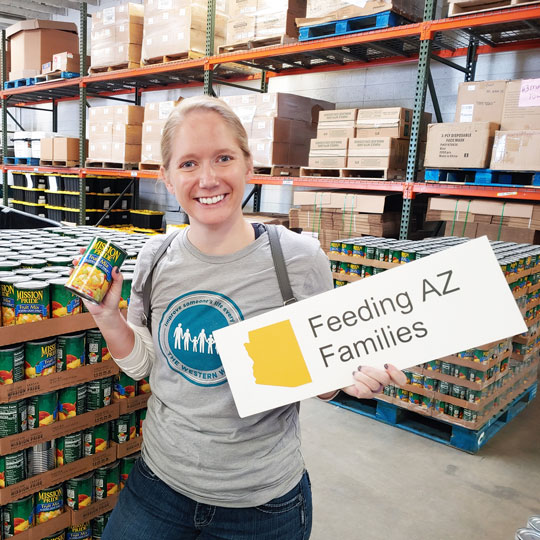 Woman holding a can of food and smiling at the camera