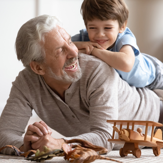 Older man smiling with younger child