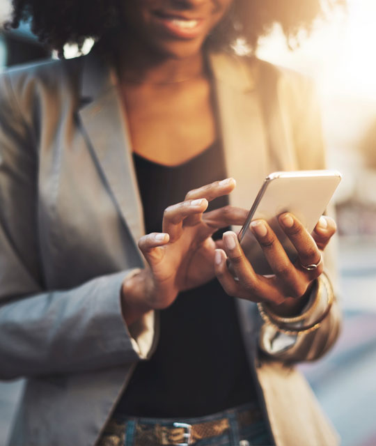 Woman's hands holding a cell phone