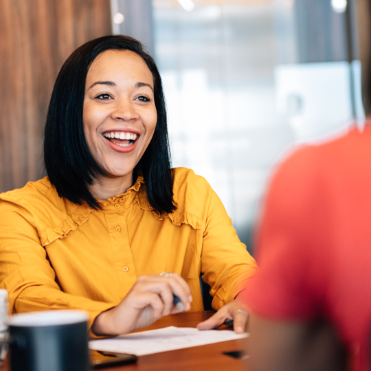 Woman smiling from across a desk