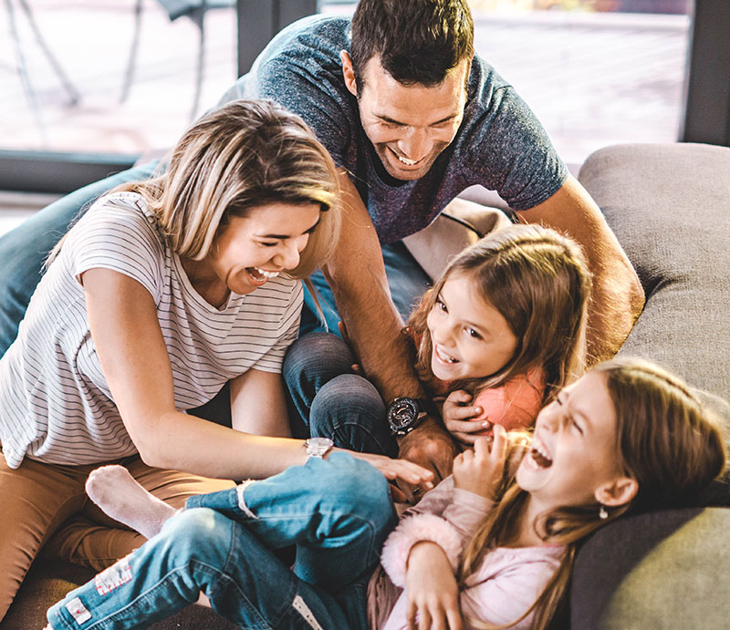 Happy family laughing on a couch